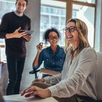 Colleagues-laughing-next-to-window