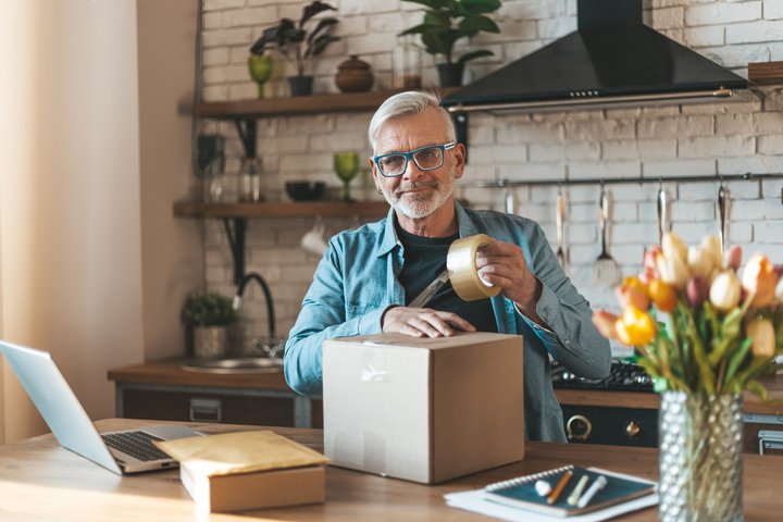 Person sealing a parcel for return shipment.